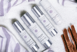 5 Circle Skin Care bottles lined up on a wooden counter for a simple stress-skin routine